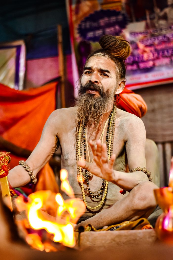about-us-02 A Hindu sadhu engaged in a traditional ritual, showcasing religious devotion and cultural attire.