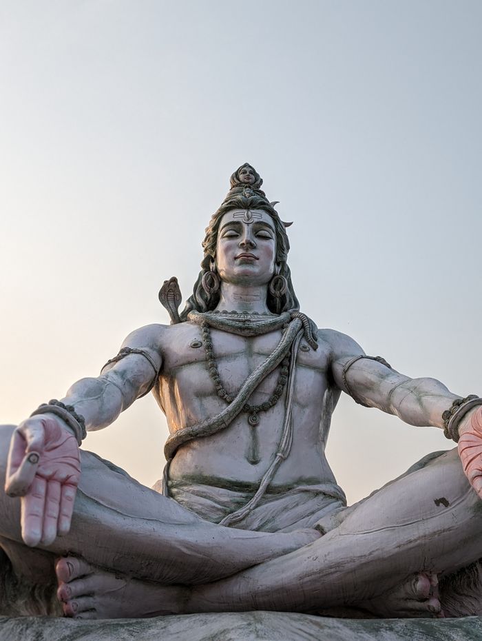 A magnificent statue of Lord Shiva captured under a serene sky evoking calmness.